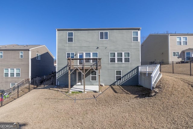 rear view of property featuring a patio area, a fenced backyard, stairs, and a deck