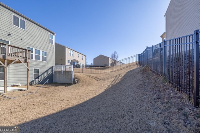 view of yard featuring stairs and fence