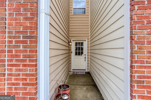 view of exterior entry with brick siding