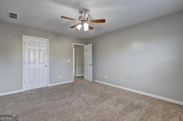 unfurnished bedroom featuring ceiling fan, carpet, visible vents, and baseboards