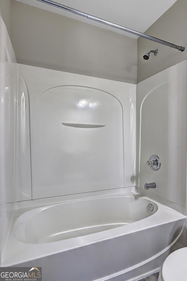 full bathroom featuring toilet and shower / washtub combination