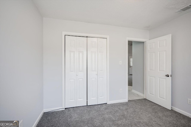 unfurnished bedroom featuring baseboards, visible vents, and carpet flooring