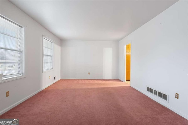 unfurnished room with light carpet, baseboards, and visible vents