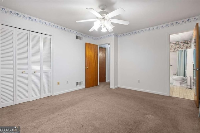 unfurnished bedroom with a closet, carpet flooring, and visible vents