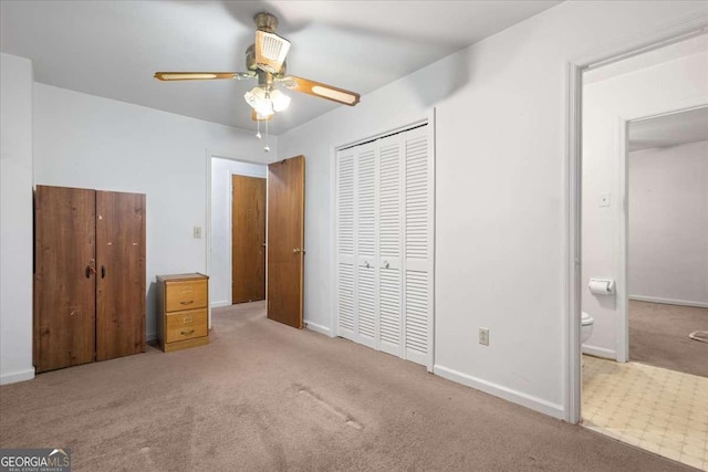 unfurnished bedroom with a closet, carpet flooring, and baseboards