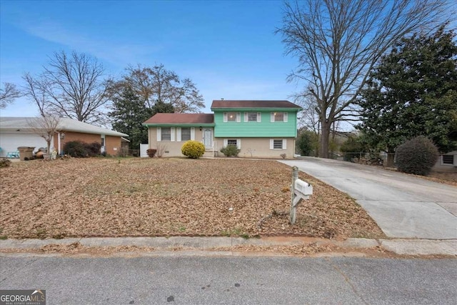 tri-level home with concrete driveway