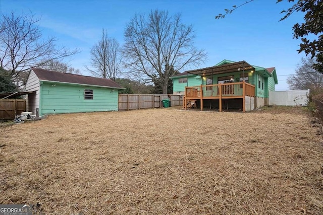 view of yard with a fenced backyard and a wooden deck