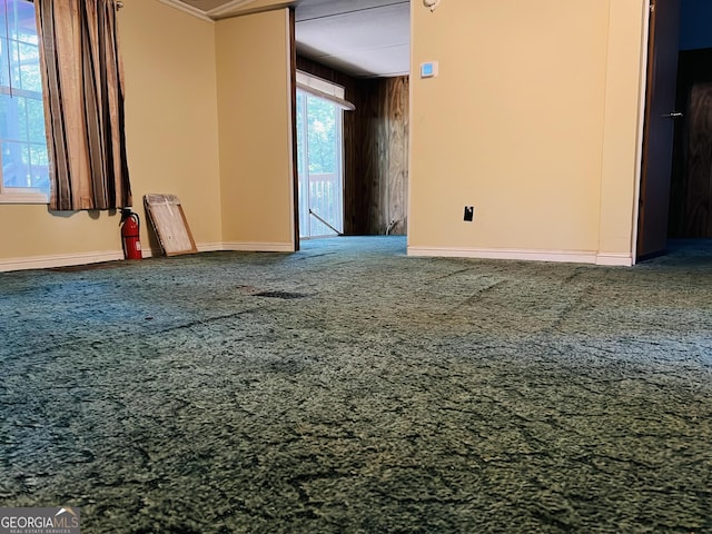 carpeted spare room featuring baseboards