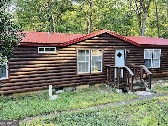 log-style house featuring crawl space and metal roof