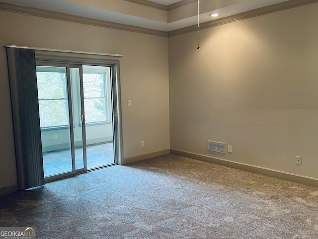 unfurnished room featuring baseboards, carpet flooring, visible vents, and crown molding