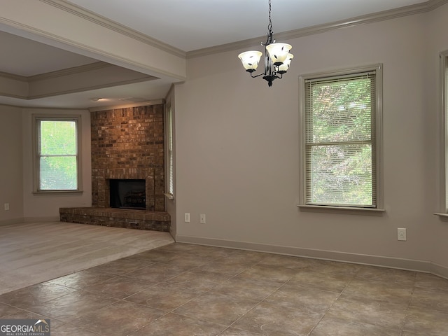 unfurnished living room with baseboards, a fireplace, a chandelier, and crown molding