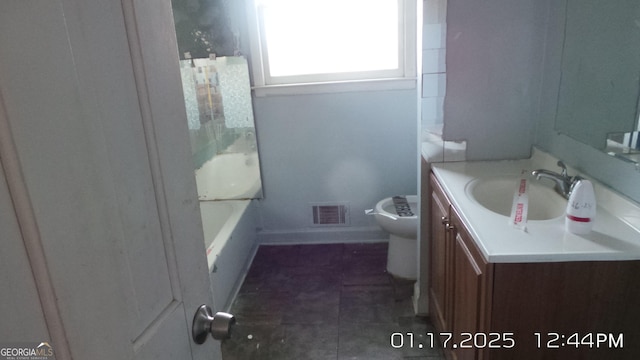 863 New Hope Dr, Hampton, GA 30228 - full bath with visible vents, baseboards, toilet, a bathtub, and vanity