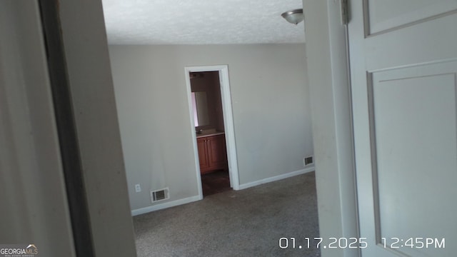 863 New Hope Dr, Hampton, GA 30228 - unfurnished bedroom featuring a textured ceiling, carpet floors, visible vents, and baseboards