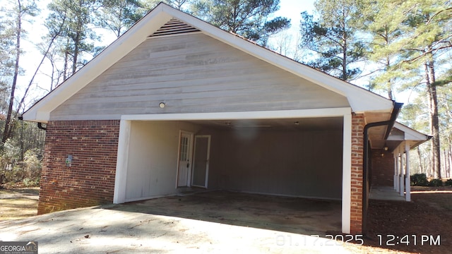 exterior space with a garage and brick siding