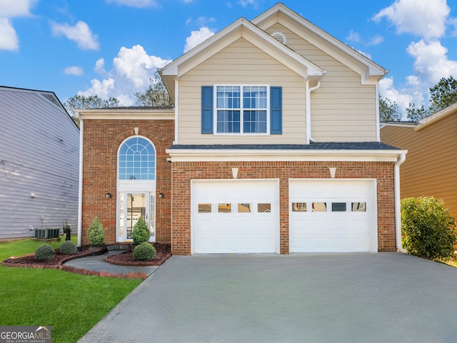 traditional-style home featuring brick siding, an attached garage, central air condition unit, roof with shingles, and driveway