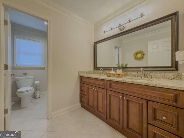 bathroom featuring ornamental molding, a sink, toilet, and double vanity