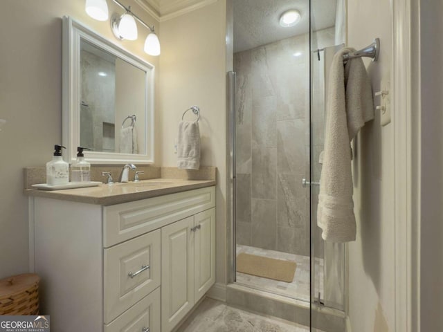 bathroom with a textured ceiling, a stall shower, and vanity