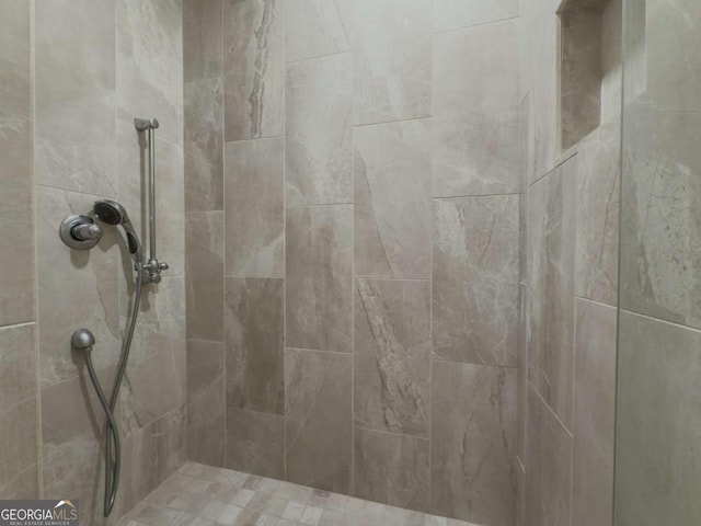 interior space featuring a tile shower