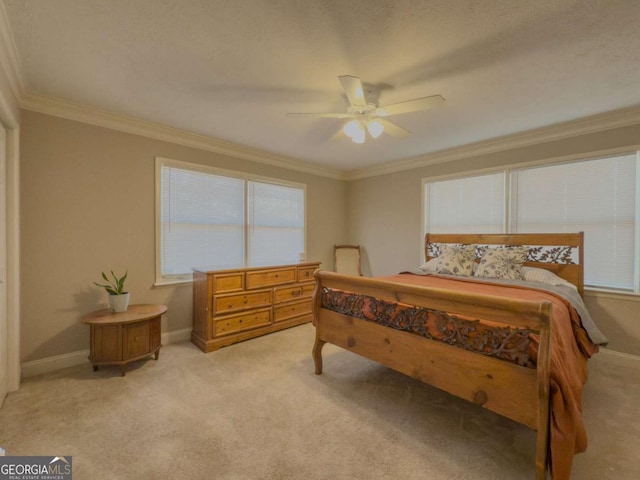 bedroom featuring crown molding, ceiling fan, baseboards, and light colored carpet