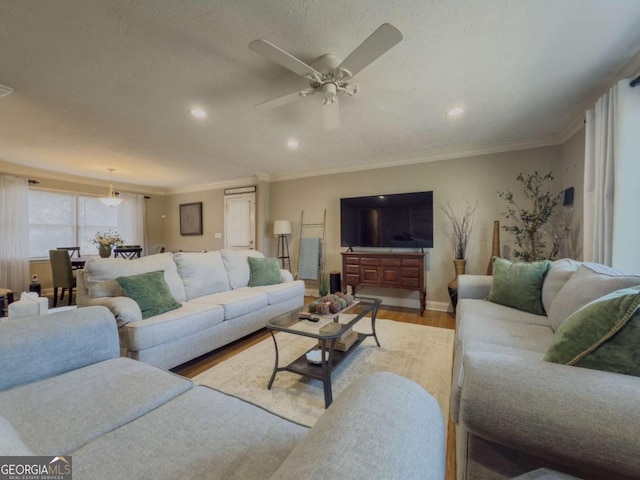 living area featuring a ceiling fan, ornamental molding, wood finished floors, and recessed lighting