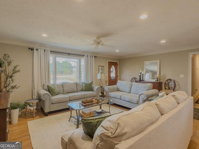 living area with light wood-style flooring, ornamental molding, a ceiling fan, and recessed lighting