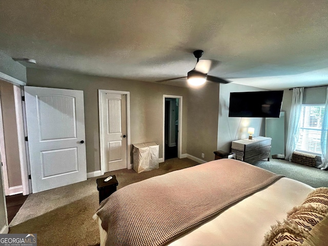 bedroom with a textured ceiling, dark carpet, a ceiling fan, and baseboards