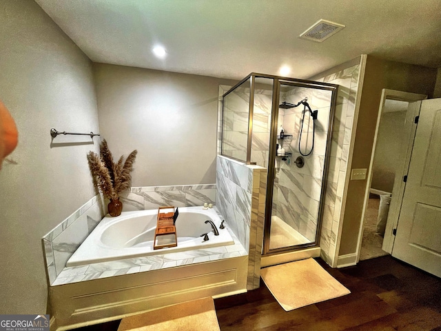 full bath with wood finished floors, visible vents, a shower stall, and a bath