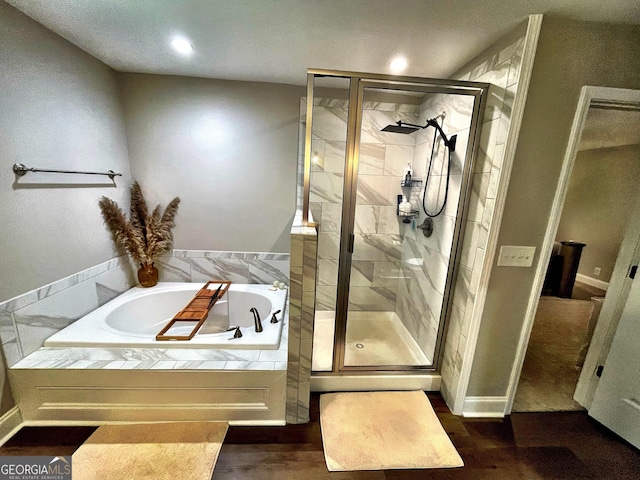 full bathroom featuring a stall shower and a garden tub