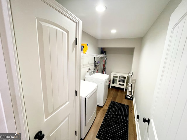 clothes washing area featuring recessed lighting, laundry area, light wood finished floors, and washing machine and clothes dryer