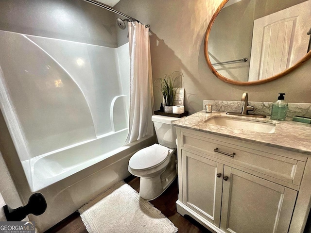 full bath featuring toilet, shower / tub combo with curtain, and vanity