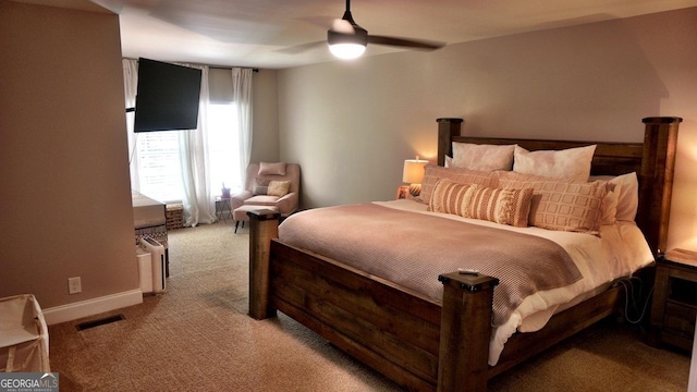 carpeted bedroom featuring visible vents, ceiling fan, and baseboards