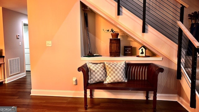 interior space featuring baseboards, stairs, visible vents, and wood finished floors