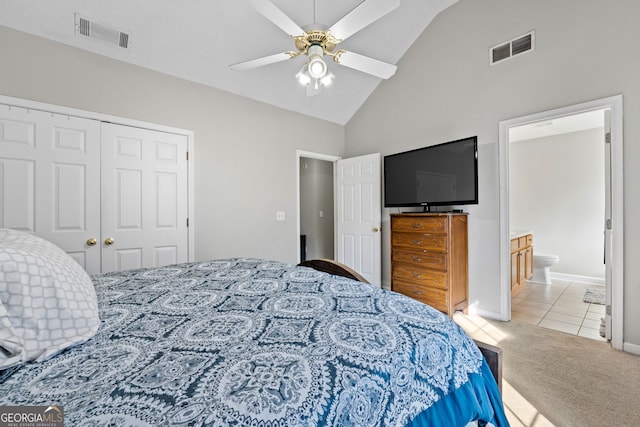 bedroom featuring a closet, light tile patterned flooring, visible vents, and light colored carpet