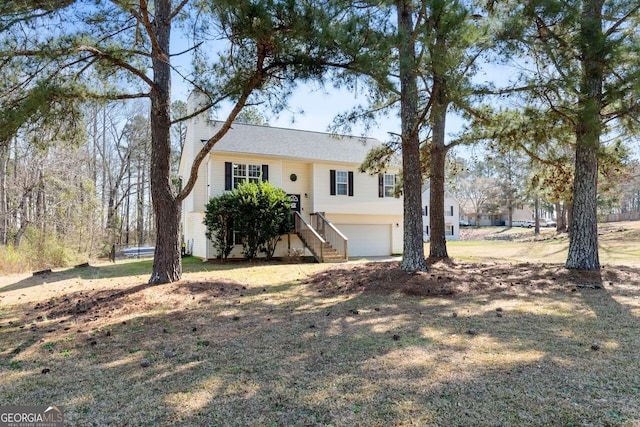 view of front of property featuring a garage, a trampoline, and a chimney