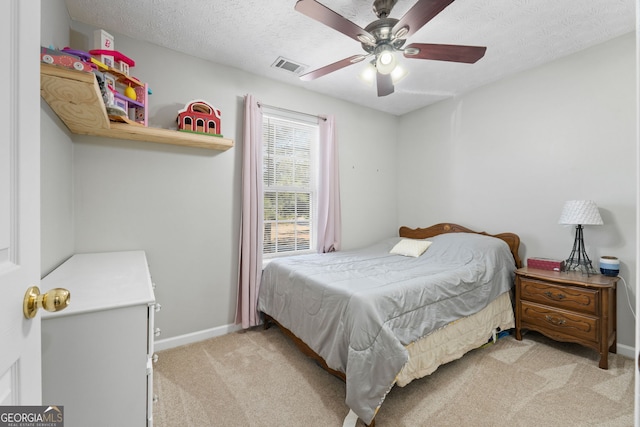 bedroom featuring light carpet, baseboards, visible vents, ceiling fan, and a textured ceiling