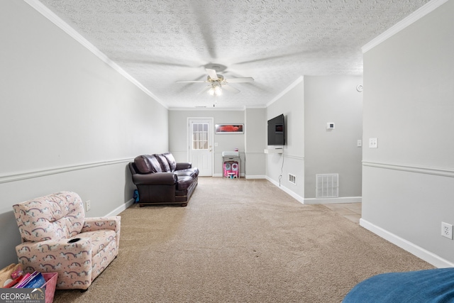 sitting room with baseboards, carpet flooring, visible vents, and crown molding