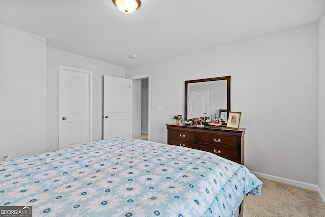 bedroom featuring baseboards and light colored carpet