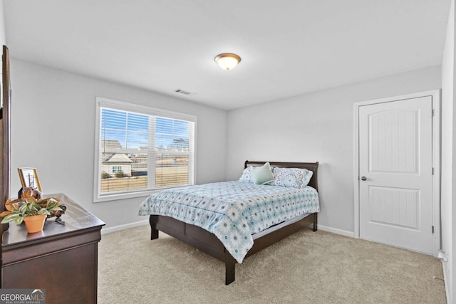 carpeted bedroom with visible vents and baseboards