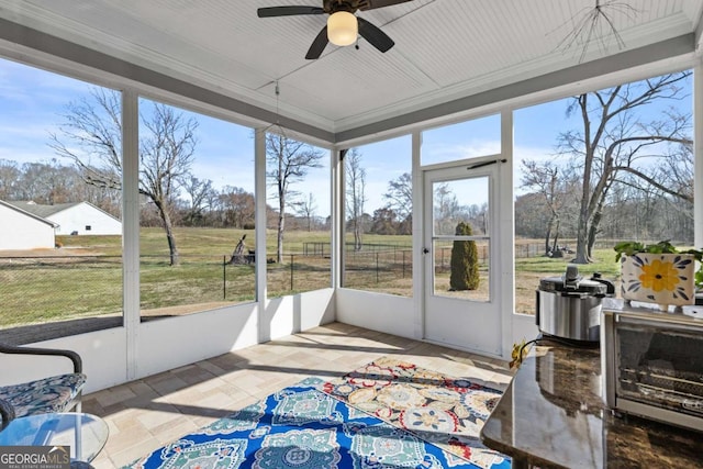 sunroom with a healthy amount of sunlight and a ceiling fan