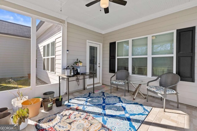 sunroom / solarium featuring a ceiling fan and a healthy amount of sunlight