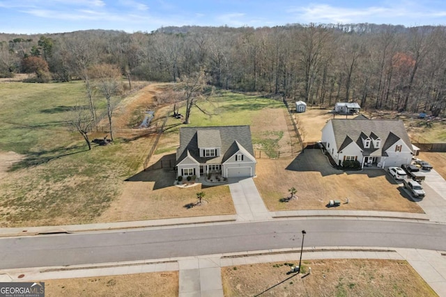 birds eye view of property with a wooded view