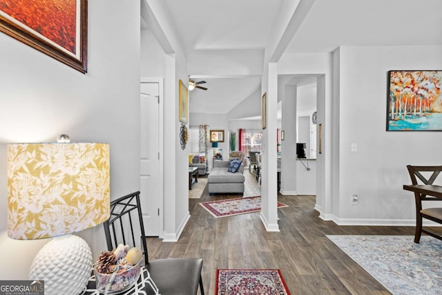 entryway with vaulted ceiling with beams, baseboards, and wood finished floors