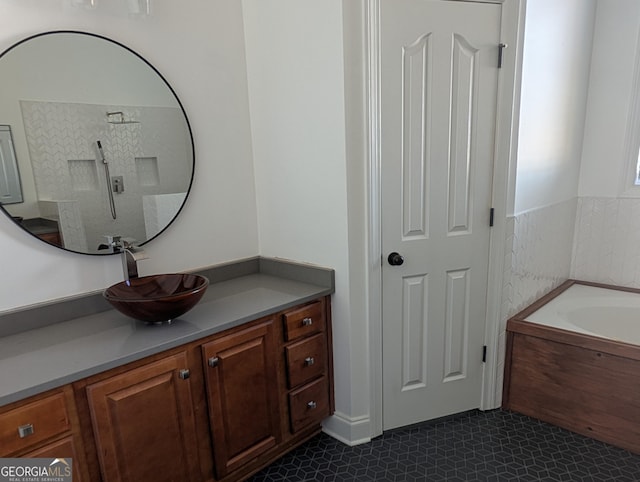 full bath featuring a garden tub, tile patterned floors, and vanity