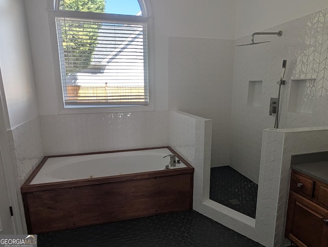 full bath with tiled shower, tile patterned flooring, vanity, and a bath