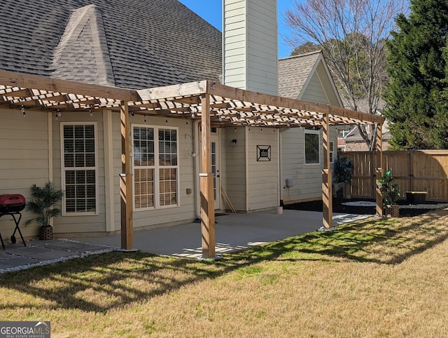 rear view of property featuring a lawn, a patio, roof with shingles, fence, and a pergola