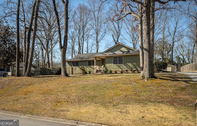 view of front of home featuring board and batten siding and fence