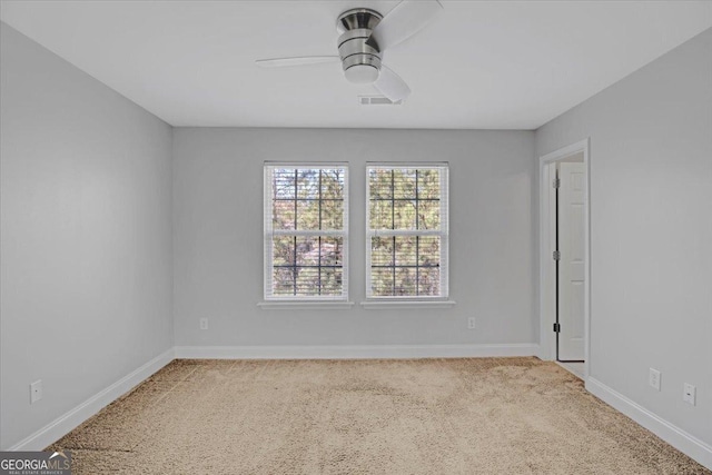 spare room featuring visible vents, baseboards, and a ceiling fan