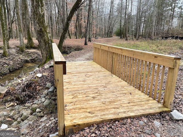 wooden deck with a forest view