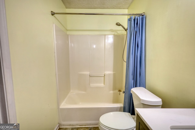 bathroom featuring toilet, shower / bath combo with shower curtain, a textured ceiling, and vanity