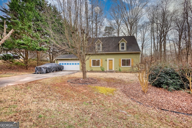 new england style home with a garage and driveway